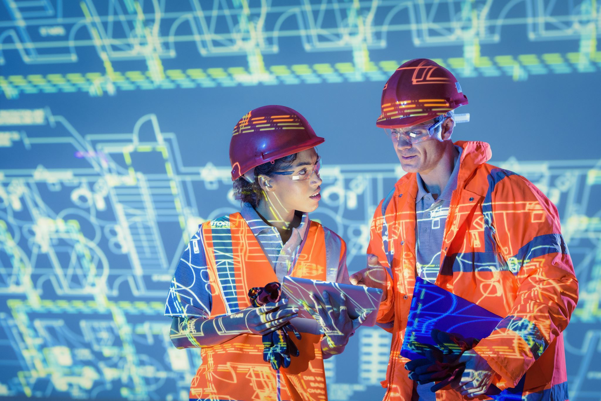 Engineers-with-digital-tablet-and-projected-plans